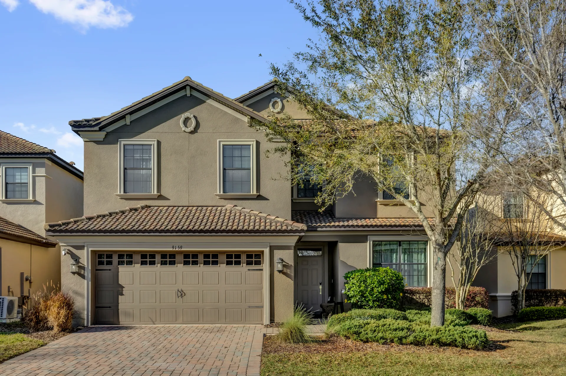 Luxury vacation villa exterior with private pool at dusk in ChampionsGate, Florida